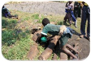 student getting well water.a